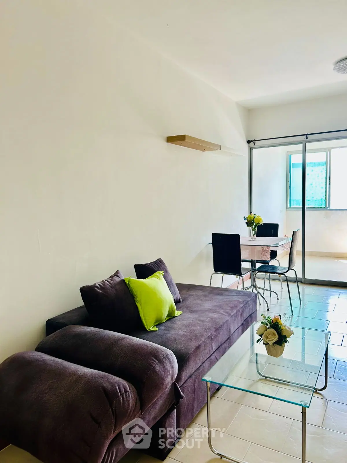 Bright living room with modern sofa and dining area, perfect for cozy gatherings.