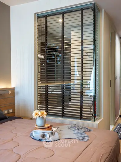 Modern bedroom with stylish decor and unique glass partition