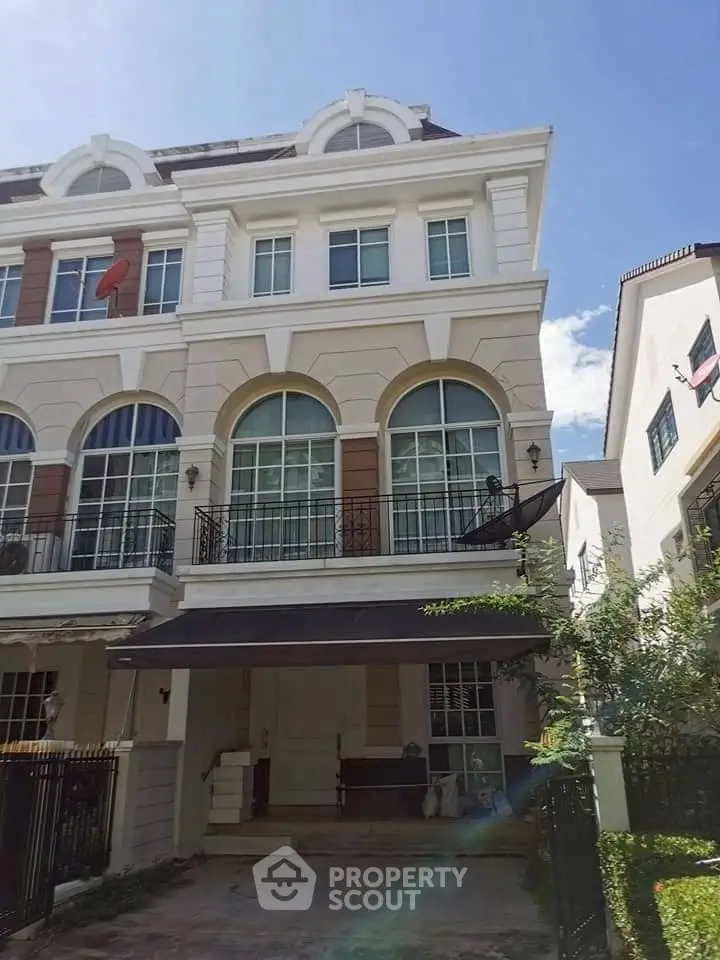 Elegant multi-story townhouse with classic architecture and spacious balconies in a serene neighborhood.
