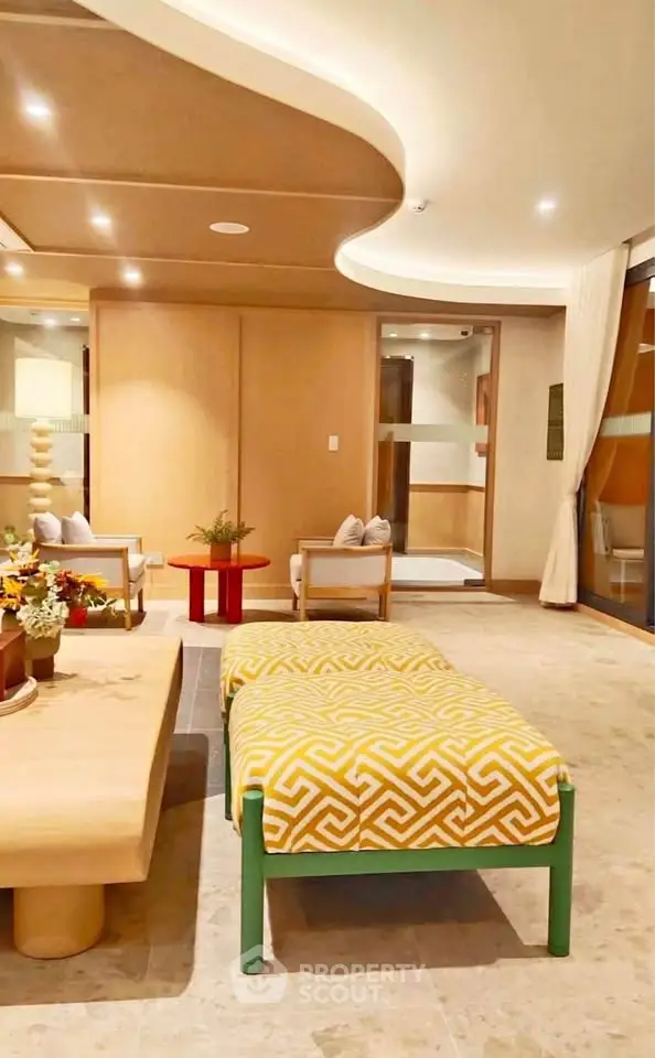 Luxurious living room with modern decor and stylish furniture, featuring a unique ceiling design and ambient lighting.