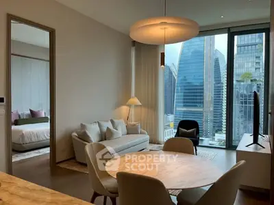 Modern living room with city view and elegant furnishings in high-rise apartment.