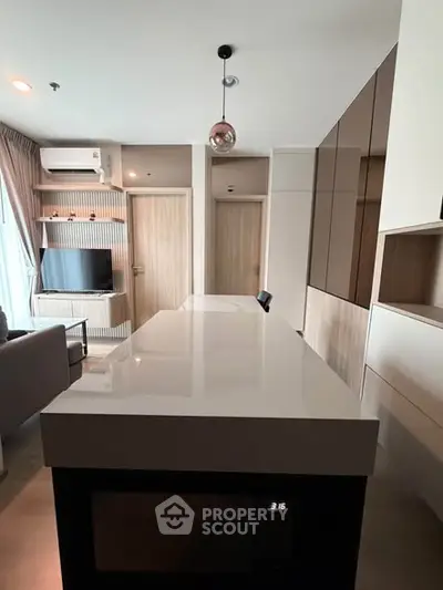 Modern kitchen with sleek design and open layout in contemporary apartment.