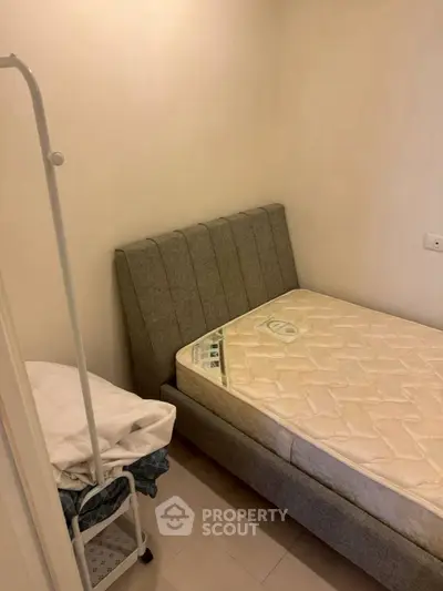 Cozy bedroom with modern bed frame and minimalist decor, perfect for restful nights.