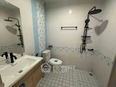 Modern bathroom with stylish fixtures and floral tile accents