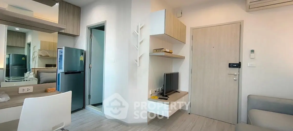 Modern apartment interior with open layout, featuring a cozy living area, sleek kitchen, and stylish decor.