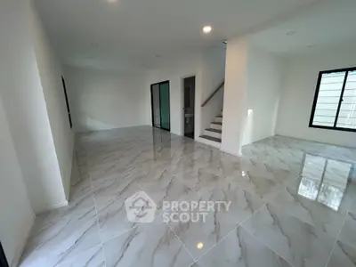 Spacious modern living room with marble flooring and natural light