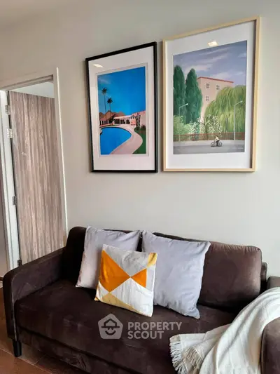 Stylish living room with modern artwork and cozy sofa, perfect for relaxation.