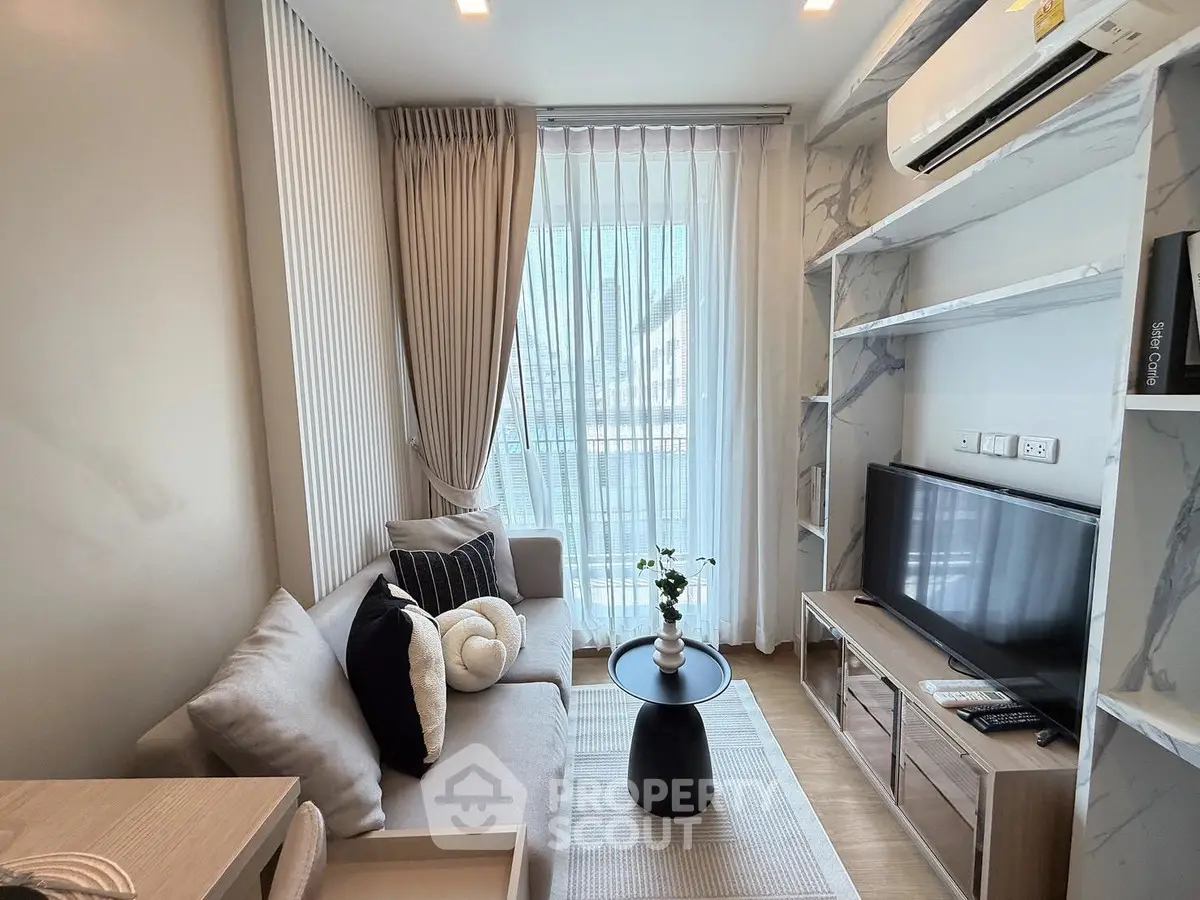 Modern living room with stylish decor, cozy sofa, and large window for natural light.