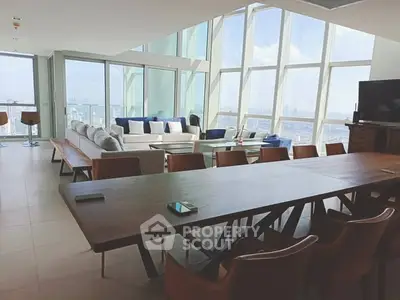 Luxurious penthouse living room with panoramic city views and modern furnishings.
