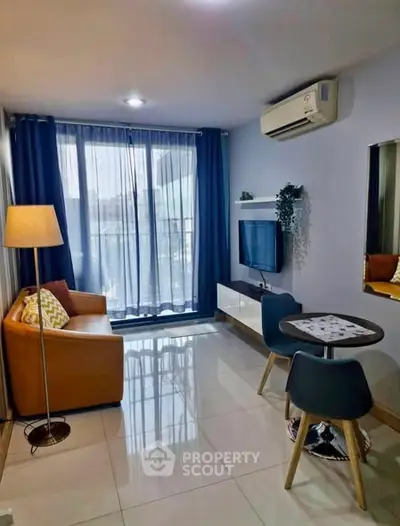 Modern living room with stylish decor, featuring a cozy sofa, dining set, and wall-mounted TV.