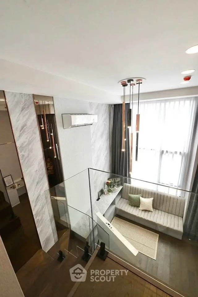 Modern duplex interior with stylish lighting and cozy seating area