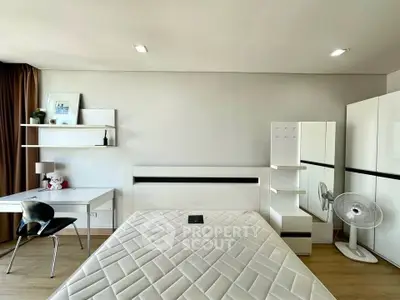 Modern bedroom with minimalist furniture and ample natural light