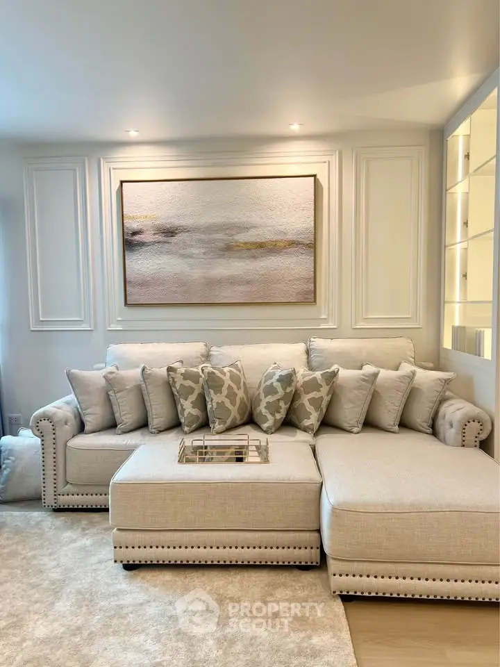 Elegant living room with plush sectional sofa and modern wall art