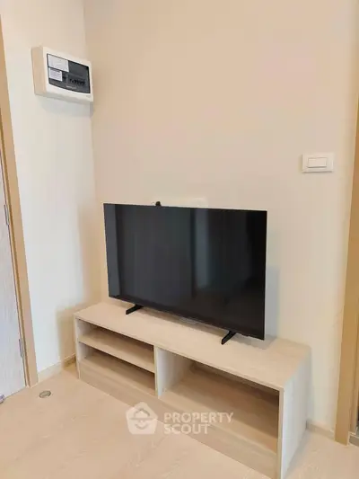 Modern living room with sleek TV setup and minimalist wooden stand