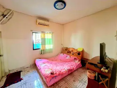 Cozy bedroom with ample natural light, air conditioning, and a comfortable double bed, ideal for restful nights in a welcoming home environment.