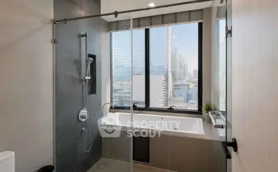 Luxurious bathroom with city view and modern bathtub in high-rise apartment.