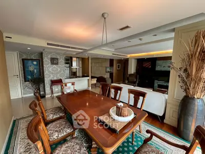 Luxurious dining and living area with elegant wooden furniture and open layout