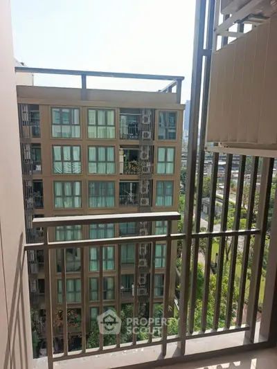 Modern apartment balcony with city view and neighboring building