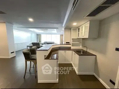 Spacious open-layout kitchen with modern design and adjacent living area