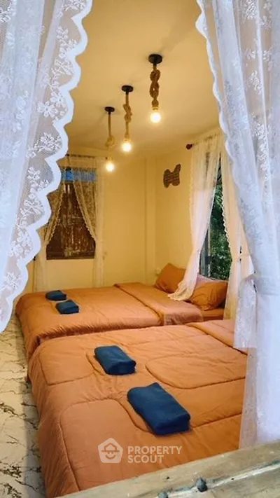Cozy bedroom with twin beds and elegant lace curtains
