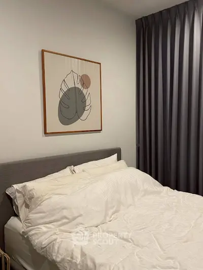 Cozy bedroom with modern decor and elegant curtains, perfect for relaxation.