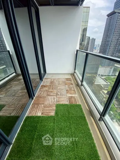 Modern balcony with city view and artificial grass flooring in high-rise apartment.