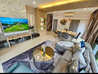 Luxurious modern living room with elegant decor and open dining area, featuring stylish furniture and ambient lighting.