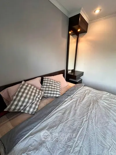 Cozy bedroom with modern decor and stylish lighting, perfect for relaxation.