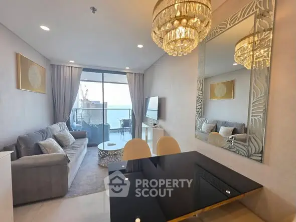 Luxurious living room with elegant chandelier and stunning balcony view