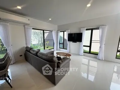 Spacious modern living room with sleek design and large windows