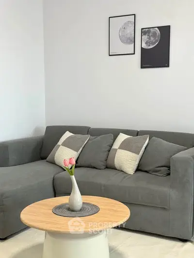 Modern living room with gray sofa and stylish decor, perfect for cozy relaxation.