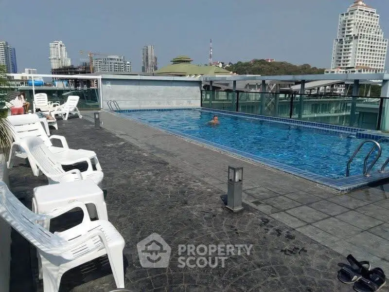 Luxurious rooftop pool with stunning city views and relaxing lounge chairs, perfect for leisure and entertainment.