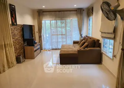 Spacious living room with modern decor and large windows for natural light