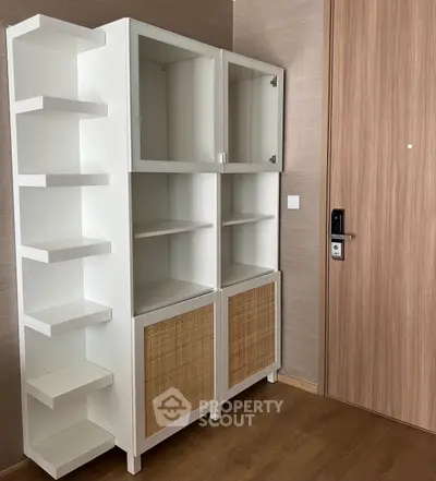 Modern white storage cabinet with wooden accents in a stylish interior space.