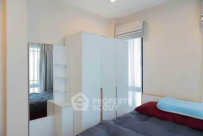 Cozy bedroom with modern wardrobe and large window for natural light