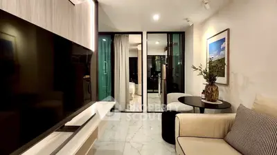 Modern living room with sleek TV and cozy seating area