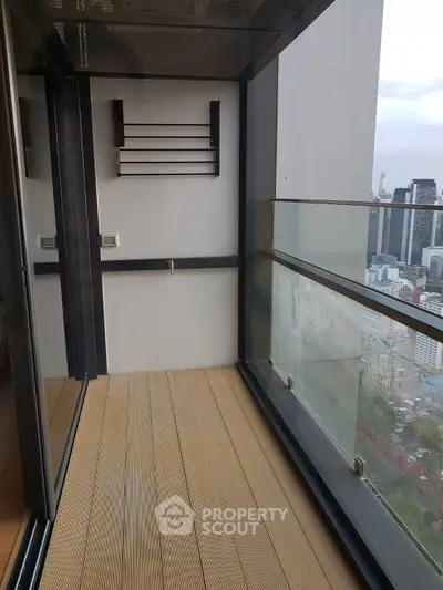 Modern balcony with city view and glass railing in high-rise building