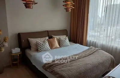 Elegant bedroom with modern lighting and city view, featuring cozy bedding and stylish decor.