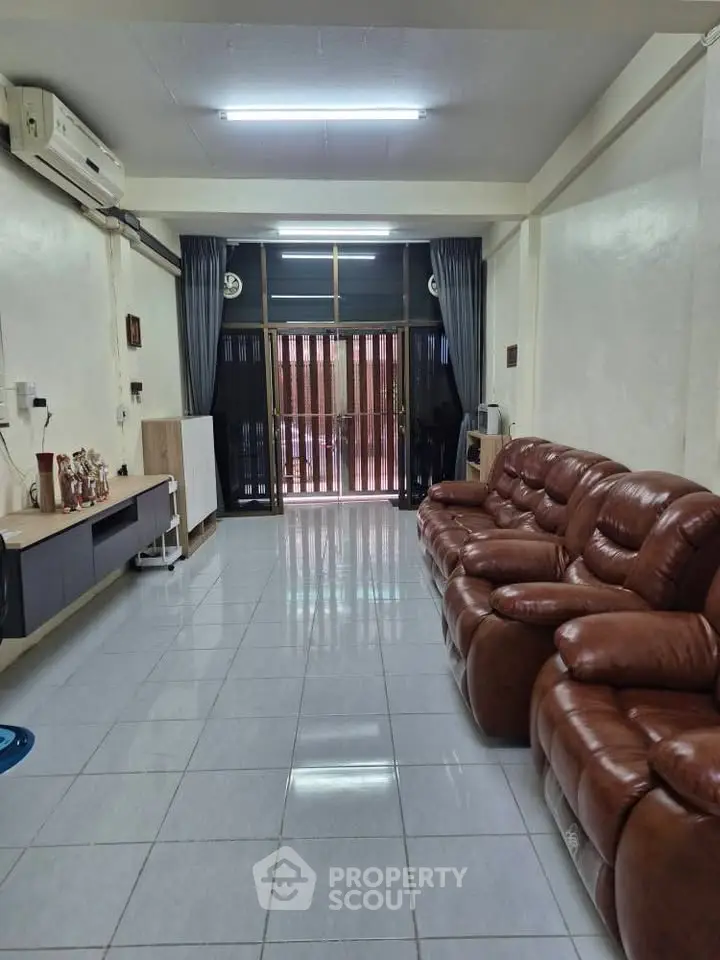 Spacious living room with leather sofas and modern decor