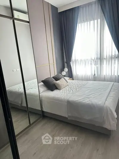 Modern bedroom with stylish decor and ample natural light