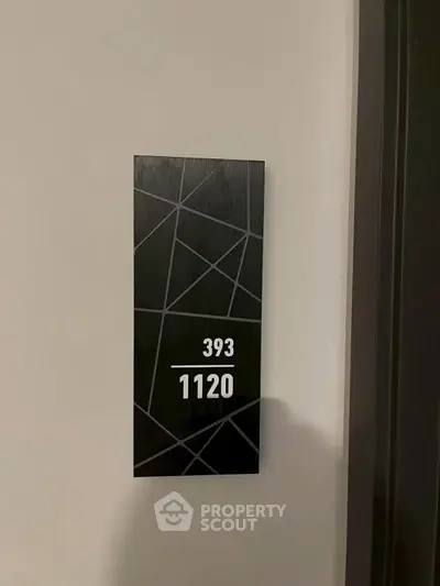 Modern apartment door number sign with sleek geometric design