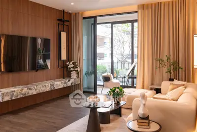 Luxurious modern living room with elegant decor and large windows opening to a garden view.