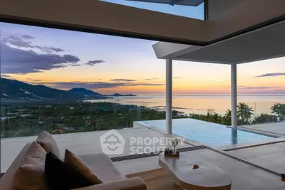 Luxurious living room with stunning ocean view and infinity pool at sunset.