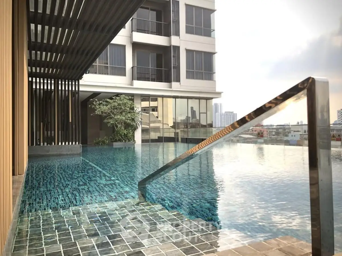 Luxurious rooftop infinity pool with city skyline view in modern apartment complex.