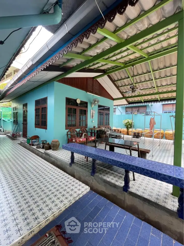 Charming traditional home with spacious outdoor patio and vibrant blue accents.