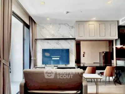 Modern living room with marble accent wall and sleek furniture in luxury apartment.