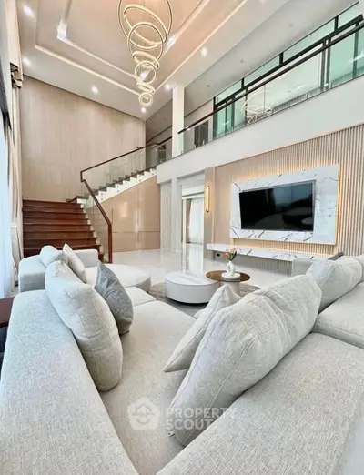 Luxurious modern living room with high ceilings and elegant staircase