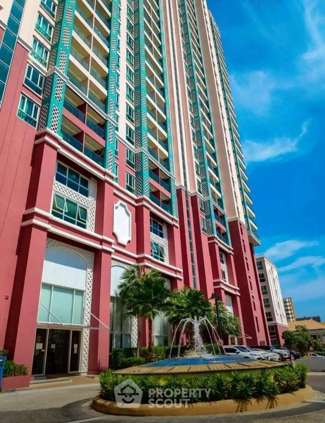 Stunning high-rise building with vibrant facade and elegant entrance in urban setting.