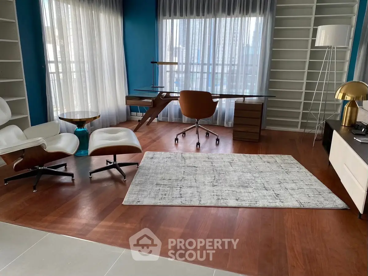 Modern study room with stylish furniture and large windows offering city views.