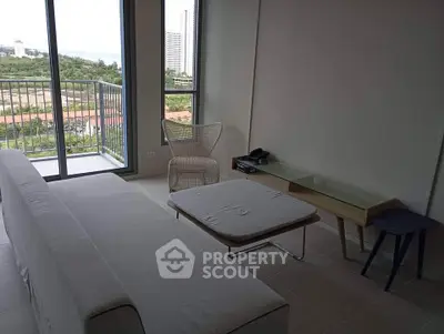 Modern living room with balcony and scenic view in high-rise apartment